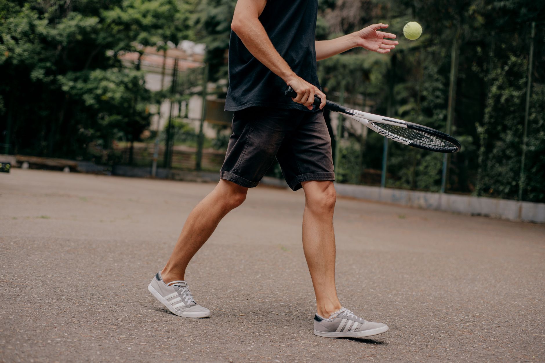 Person holding tennis racket