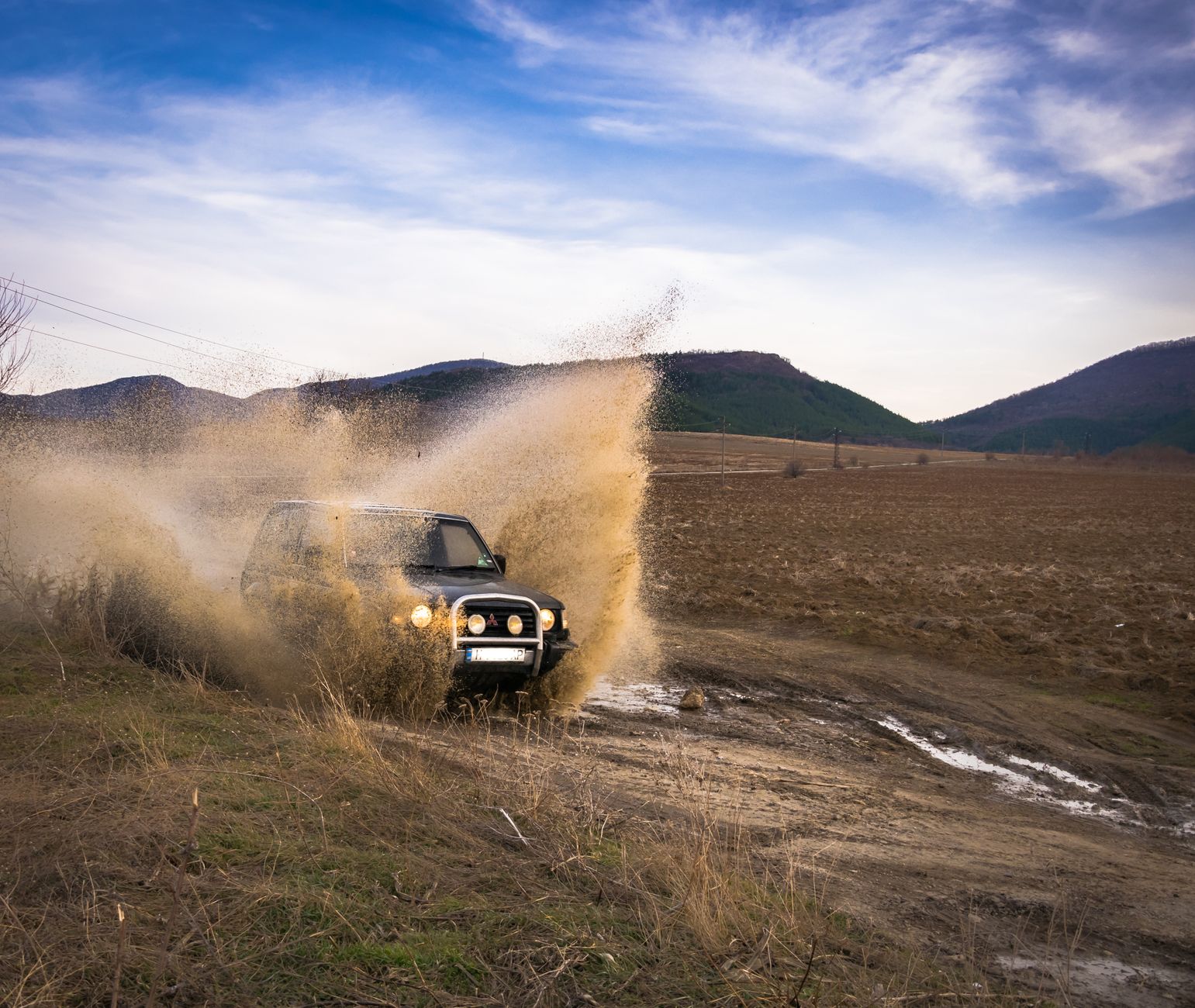 Black SUV in mud