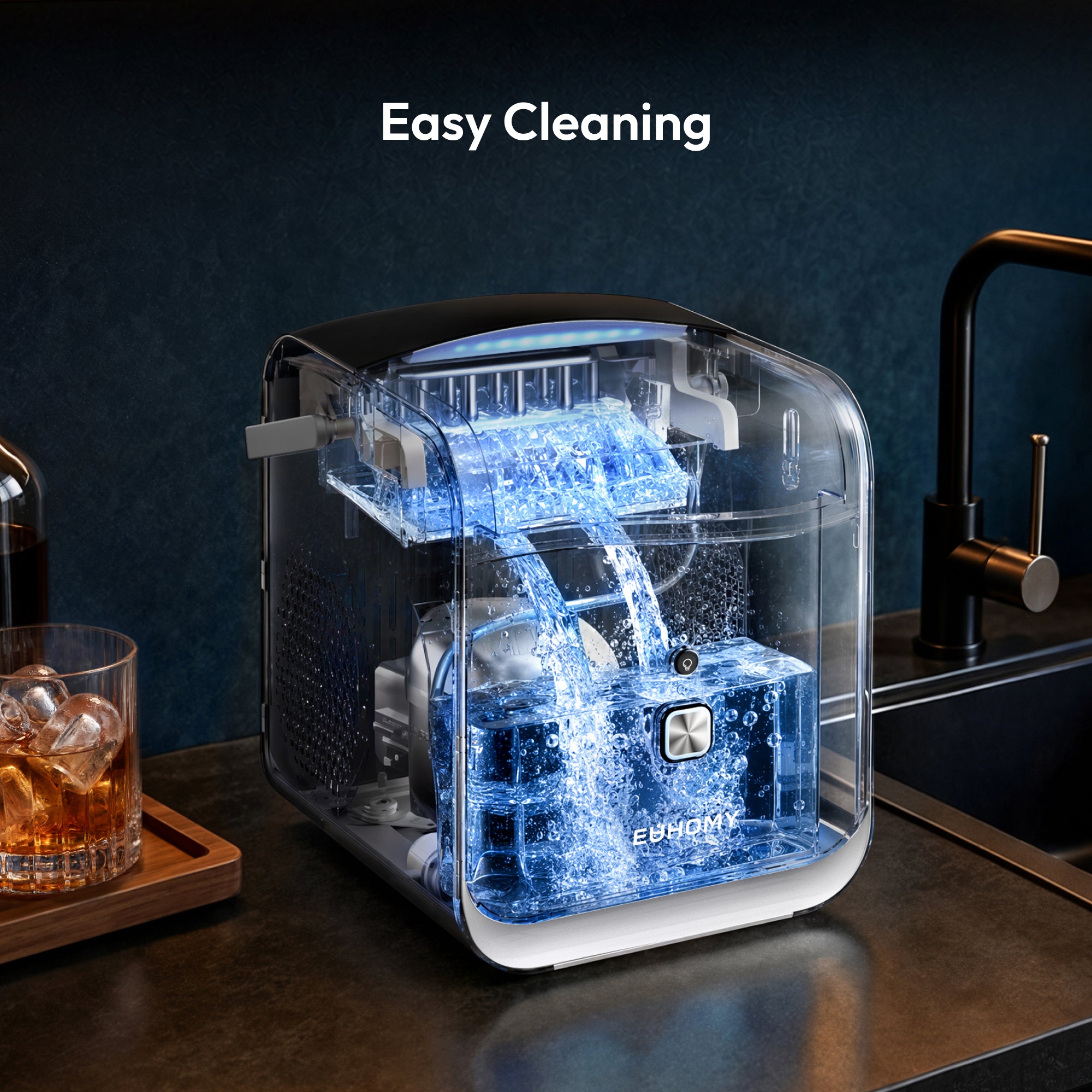 Transparent ice maker with water flowing from top dispenser for cleaning the interior chamber